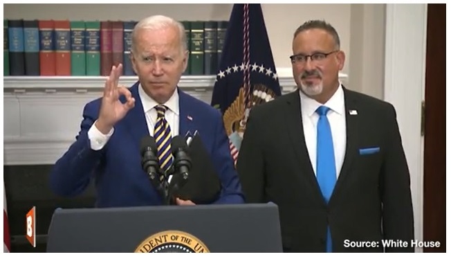 Biden flashs KKK sign in briefing.jpg